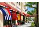 Commercial building showing off the Venice Mall with decorative awnings, international flags, and palm trees at 288 Soliera St, Nokomis, FL 34275