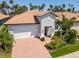 Charming single-Gathering home with lush landscaping, red tile roof, brick driveway and two car garage at 288 Soliera St, Nokomis, FL 34275