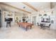 This game room offers a pool table, comfortable seating, and built-in shelving for entertainment and relaxation at 288 Soliera St, Nokomis, FL 34275
