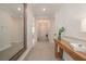 Long hallway with neutral walls, stylish console table, and a large mirror at 288 Soliera St, Nokomis, FL 34275