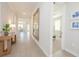 Bright hallway featuring wood-look tile floors and stylish decor, leading to an open-concept living space at 288 Soliera St, Nokomis, FL 34275
