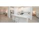 Modern kitchen featuring a large island with seating, stainless steel appliances and white cabinetry at 288 Soliera St, Nokomis, FL 34275