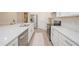Bright kitchen with a large island, stainless steel appliances, white cabinets and tile flooring at 288 Soliera St, Nokomis, FL 34275