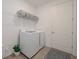 Bright laundry room with modern washer, dryer, and storage shelves at 288 Soliera St, Nokomis, FL 34275