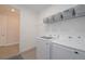Well-organized laundry room with modern appliances and wire shelving at 288 Soliera St, Nokomis, FL 34275