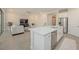 Open-concept living space featuring a kitchen island, tile flooring, and modern decor with natural light at 288 Soliera St, Nokomis, FL 34275