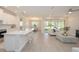 Open-concept living space featuring a spacious kitchen, dining area, and living room with plenty of natural light at 288 Soliera St, Nokomis, FL 34275
