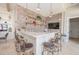 Lounge area boasts a brick wall, granite countertop bar, and casual seating for a comfortable and stylish gathering spot at 288 Soliera St, Nokomis, FL 34275