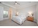 Neutral main bedroom with carpeted floors, a tray ceiling, and natural wood nightstands at 288 Soliera St, Nokomis, FL 34275