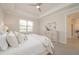 Comfortable main bedroom with a neutral color scheme, tray ceiling, and natural light at 288 Soliera St, Nokomis, FL 34275