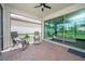 Spacious, screened patio with brick flooring and comfortable seating arrangement with views of greenery at 288 Soliera St, Nokomis, FL 34275