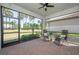 Enclosed brick patio with ceiling fan, screened windows, and relaxing outdoor seating at 288 Soliera St, Nokomis, FL 34275