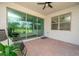 Screened patio featuring brick flooring, ceiling fan, and sliding glass doors for seamless indoor-outdoor living at 288 Soliera St, Nokomis, FL 34275