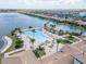 Aerial view of a large community pool surrounded by palm trees and lounge chairs at 288 Soliera St, Nokomis, FL 34275