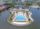 Aerial view of community pool area, surrounded by palm trees with bay views and a large pool at 288 Soliera St, Nokomis, FL 34275