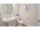Well-lit powder room with pedestal sink, and a framed art print at 288 Soliera St, Nokomis, FL 34275