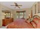 Comfortable bedroom featuring a ceiling fan, and a window providing ample natural light at 335 Auburn Woods Cir, Venice, FL 34292