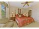 Comfortable bedroom with a four-poster bed and a beige armchair at 335 Auburn Woods Cir, Venice, FL 34292