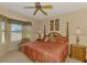 Serene bedroom with a four-poster bed, bay window, and calming decor at 335 Auburn Woods Cir, Venice, FL 34292