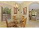 Inviting breakfast nook with a glass table, chandelier, and a view into the adjacent living space at 335 Auburn Woods Cir, Venice, FL 34292