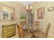 Cozy breakfast nook featuring a glass table, decorative chandelier, and bright natural light at 335 Auburn Woods Cir, Venice, FL 34292
