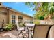 Inviting patio area with brick pavers, comfortable seating, and lush landscaping creating a serene outdoor space at 335 Auburn Woods Cir, Venice, FL 34292