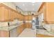 Spacious kitchen featuring granite counters, stainless steel appliances, and plenty of cabinet storage at 335 Auburn Woods Cir, Venice, FL 34292