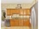 Bright kitchen featuring stainless steel appliances, granite countertops, and wooden cabinets at 335 Auburn Woods Cir, Venice, FL 34292