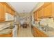 Open-concept kitchen with stainless steel appliances, granite counters, and a view to the breakfast nook at 335 Auburn Woods Cir, Venice, FL 34292