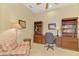 A home office featuring built-in bookshelves and a comfortable chair at 335 Auburn Woods Cir, Venice, FL 34292