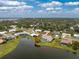 A beautiful home highlighted by red circle overlooking a serene lake with lush green surroundings at 351 Eden Dr, Englewood, FL 34223