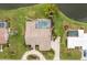 Aerial shot showcasing a home with a screened-in pool, meticulous landscaping and circular driveway at 351 Eden Dr, Englewood, FL 34223