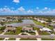 Aerial view of a single-Gathering home situated on a lake at 351 Eden Dr, Englewood, FL 34223