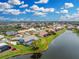 A beautiful waterfront home with a charming garden and a view highlighted by a red circle overlooking a serene lake at 351 Eden Dr, Englewood, FL 34223
