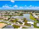 Aerial view highlighted by red circle of waterfront home with lush landscaping and serene lake views at 351 Eden Dr, Englewood, FL 34223