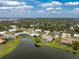 A beautiful home overlooking a serene lake with lush green surroundings at 351 Eden Dr, Englewood, FL 34223