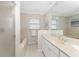 Neutral tone bathroom featuring a glass door shower, soaking tub, and cream colored vanity at 351 Eden Dr, Englewood, FL 34223