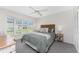 Bedroom featuring neutral colored walls and carpet, bay windows, and a ceiling fan at 351 Eden Dr, Englewood, FL 34223
