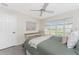 Bedroom featuring neutral walls, carpet, a bed with a wicker headboard, bay windows and a ceiling fan at 351 Eden Dr, Englewood, FL 34223