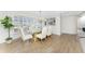 Dining room with lots of natural light and wood-look tile floors at 351 Eden Dr, Englewood, FL 34223