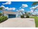 Home showcasing a blue garage door, neutral paint and mature landscaping at 351 Eden Dr, Englewood, FL 34223
