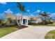 Attractive home with a well-manicured lawn, mature palms, and a inviting driveway at 351 Eden Dr, Englewood, FL 34223