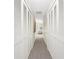 Hallway featuring full wall closets with louvered doors and carpet at 351 Eden Dr, Englewood, FL 34223