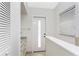 Bright hallway with a white door and marble countertops at 351 Eden Dr, Englewood, FL 34223