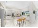 Spacious kitchen featuring ample counter space, bar seating, and modern appliances at 351 Eden Dr, Englewood, FL 34223