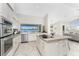Open kitchen features stainless steel appliances, an island, and a window with views of the water at 351 Eden Dr, Englewood, FL 34223