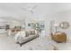 Open living room with tile flooring, a ceiling fan, and views into the kitchen and dining area at 351 Eden Dr, Englewood, FL 34223