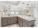 Bathroom featuring marble floors, granite countertops, double sinks, stained glass window, and large wall mirror at 351 Eden Dr, Englewood, FL 34223
