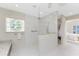 Bathroom featuring marble floors, granite countertops, stained glass window, and open shower with glass at 351 Eden Dr, Englewood, FL 34223