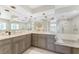 Bathroom featuring marble floors, granite countertops, double sinks, stained glass window, and open shower with glass at 351 Eden Dr, Englewood, FL 34223